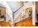 Elegant foyer with hardwood floors, staircase, and arched doorway at 1616 Kirkby Ln, Raleigh, NC 27614
