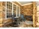 Cozy stone porch featuring rocking chairs and ample natural light, perfect for relaxing at 1616 Kirkby Ln, Raleigh, NC 27614
