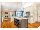 Spacious kitchen featuring a marble island with wine storage, stainless steel appliances, and adjacent living area at 1616 Kirkby Ln, Raleigh, NC 27614