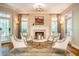 Cozy living room featuring a fireplace, stylish seating, and abundant natural light at 1616 Kirkby Ln, Raleigh, NC 27614