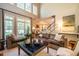Bright living room features large windows, comfortable seating, and a staircase, perfect for relaxing and entertaining at 1616 Kirkby Ln, Raleigh, NC 27614