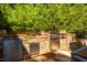 Outdoor kitchen with stainless steel appliances and stone accents at 1616 Kirkby Ln, Raleigh, NC 27614