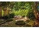 Outdoor stone patio with a fire pit and built-in seating at 1616 Kirkby Ln, Raleigh, NC 27614