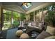 Relaxing sunroom with wicker furniture, ample seating, and views of the surrounding greenery at 1616 Kirkby Ln, Raleigh, NC 27614