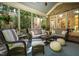 Inviting sunroom with wicker furniture, comfortable seating, and lush outdoor views at 1616 Kirkby Ln, Raleigh, NC 27614