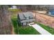Beautiful aerial view of a home with a well-maintained lawn and a long concrete driveway at 163 Nashua Dr, Louisburg, NC 27549