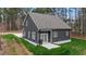 Exterior angled view of the gray home featuring patio, siding, and a gray roof at 163 Nashua Dr, Louisburg, NC 27549