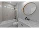 Bathroom showcasing marble countertop, brass mirror frame, a toilet, and a tiled shower at 163 Nashua Dr, Louisburg, NC 27549