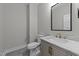 Bathroom featuring toilet, marble countertop, a square mirror, and a gray vanity at 163 Nashua Dr, Louisburg, NC 27549