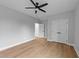 A bedroom featuring light gray walls, and wood-look flooring, ceiling fan and double door closet at 163 Nashua Dr, Louisburg, NC 27549