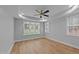 Well-lit bedroom with neutral paint, a tray ceiling and large windows at 163 Nashua Dr, Louisburg, NC 27549