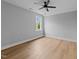 Well-lit bedroom featuring neutral paint, luxury vinyl plank flooring and a modern ceiling fan at 163 Nashua Dr, Louisburg, NC 27549