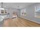 Bright dining area featuring hardwood floors, a sliding glass door, and modern pendant lighting at 163 Nashua Dr, Louisburg, NC 27549