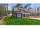 Beautiful home exterior with a covered porch, manicured lawn and gray siding at 163 Nashua Dr, Louisburg, NC 27549