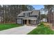 Charming two-story home with dark siding, covered front porch, and well-maintained lawn at 163 Nashua Dr, Louisburg, NC 27549