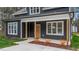 Charming home exterior with number 163 and wood porch posts on a manicured lawn at 163 Nashua Dr, Louisburg, NC 27549