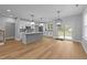 Open kitchen featuring an island, pendant lighting, stainless appliances, and sliding doors to the backyard at 163 Nashua Dr, Louisburg, NC 27549