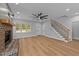 Open living room with a brick fireplace, staircase, and an entrance to the front porch at 163 Nashua Dr, Louisburg, NC 27549