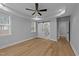 Primary bedroom with a tray ceiling, large windows and a view into the main bathroom at 163 Nashua Dr, Louisburg, NC 27549