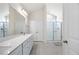 Bright bathroom featuring a double vanity, white cabinets, and a glass-enclosed shower at 212 Thunder Forest Ln, Wendell, NC 27591