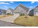 Home exterior featuring attached garage and driveway, landscaped with grass at 212 Thunder Forest Ln, Wendell, NC 27591
