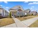Inviting single-story home showcasing stone accents, light siding, and a well-maintained front yard at 212 Thunder Forest Ln, Wendell, NC 27591