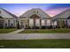 Charming single-story home featuring stone accents, a welcoming front porch, and manicured landscaping at 212 Thunder Forest Ln, Wendell, NC 27591