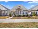 Charming single-story home featuring stone accents, a welcoming front porch, and manicured landscaping at 212 Thunder Forest Ln, Wendell, NC 27591