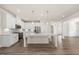 Bright eat-in kitchen features white cabinets, stainless appliances, and an island with bar seating at 212 Thunder Forest Ln, Wendell, NC 27591