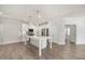 Bright eat-in kitchen features white cabinets, stainless appliances, and an island with bar seating at 212 Thunder Forest Ln, Wendell, NC 27591