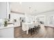 Bright eat-in kitchen features white cabinets, stainless appliances, and an island with bar seating at 212 Thunder Forest Ln, Wendell, NC 27591