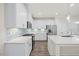 Bright eat-in kitchen features white cabinets, stainless appliances, and an island with bar seating at 212 Thunder Forest Ln, Wendell, NC 27591
