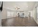 Open-concept living space featuring hardwood floors, and views into the spacious kitchen at 212 Thunder Forest Ln, Wendell, NC 27591