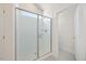 Elegant tiled shower with glass enclosure and natural light from a transom window at 212 Thunder Forest Ln, Wendell, NC 27591