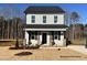 Charming two-story home with gray siding, black shutters, and well-manicured landscaping at 260 Longbow Dr, Middlesex, NC 27557