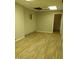 Unfinished basement area with wood-look flooring and a small window at 2602 Fayetteville St, Durham, NC 27707
