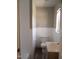 Bathroom featuring a toilet and sink with white subway tile surround at 2602 Fayetteville St, Durham, NC 27707