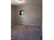 Bedroom with gray walls, carpet, and a window providing natural light at 2602 Fayetteville St, Durham, NC 27707