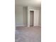 Bright bedroom with neutral gray walls and carpet, and closet with sliding doors at 2602 Fayetteville St, Durham, NC 27707