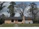 Single-story house featuring stone accents, a front yard, and a gray roof on a sunny day at 2602 Fayetteville St, Durham, NC 27707