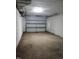 Empty garage featuring a white concrete floor and a rolling garage door at 2602 Fayetteville St, Durham, NC 27707