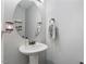 Well-lit powder room features a pedestal sink, decorative mirror, and modern fixtures at 288 Joseph Alexander Dr, Fuquay Varina, NC 27526