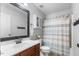 Updated bathroom with vanity, toilet, shower with curtain, and decorative mirror at 288 Joseph Alexander Dr, Fuquay Varina, NC 27526