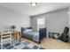 Cozy bedroom featuring a blue bed set, desk, and stylish decor, creating a comfortable retreat at 288 Joseph Alexander Dr, Fuquay Varina, NC 27526