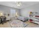 Bright bedroom with natural light, featuring a patterned bedspread, desk, and stylish decor at 288 Joseph Alexander Dr, Fuquay Varina, NC 27526