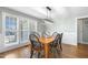 Bright dining room features hardwood floors, updated lighting and a large window at 288 Joseph Alexander Dr, Fuquay Varina, NC 27526