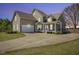 Charming home with inviting front porch, two-car garage, and landscaped front yard with circular driveway at 288 Joseph Alexander Dr, Fuquay Varina, NC 27526