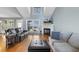 Open-concept living room with hardwood floors, a fireplace, and views of the backyard at 288 Joseph Alexander Dr, Fuquay Varina, NC 27526