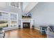 Bright living room features a fireplace with mantel, tall windows and hardwood floors at 288 Joseph Alexander Dr, Fuquay Varina, NC 27526
