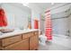 Bright bathroom with a single vanity, bathtub and shower at 301 Kinsale Dr, Chapel Hill, NC 27517